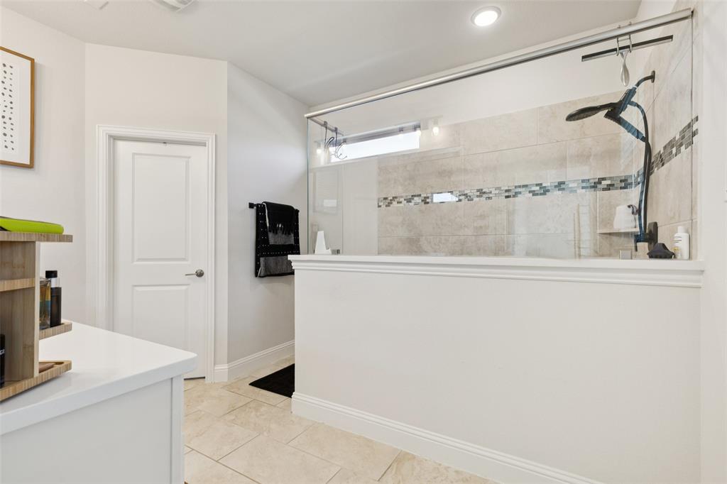 2236 Madison Street Carrollton, TX 75010 - Photo 26 of 37 a bathroom with a shower and a mirror