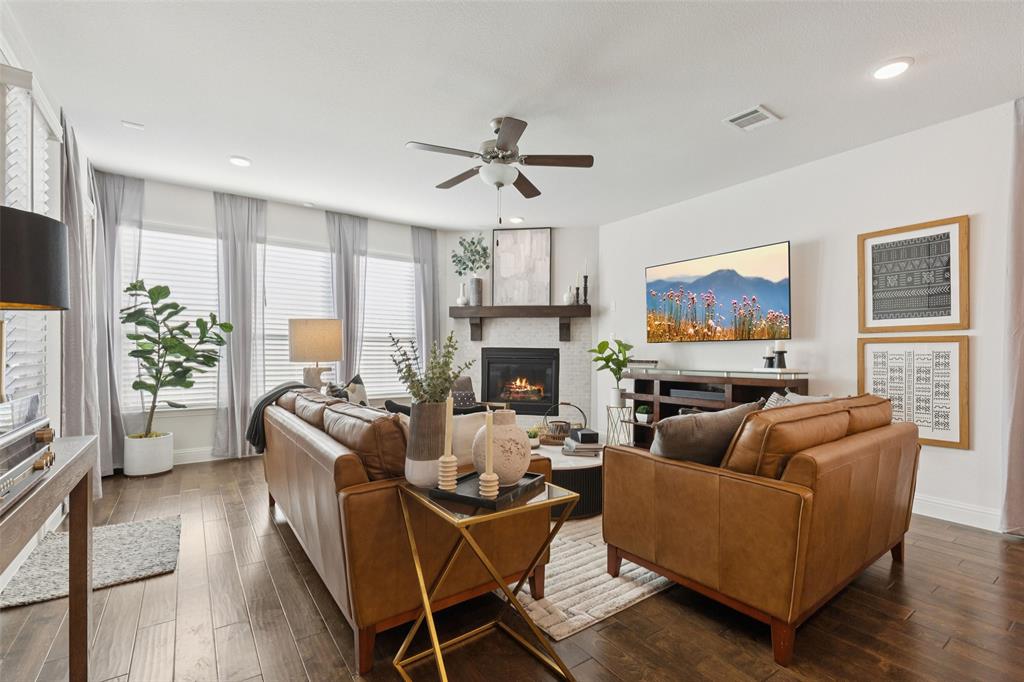 2236 Madison Street Carrollton, TX 75010 - Photo 7 of 37 a living room with furniture a fireplace and a flat screen tv