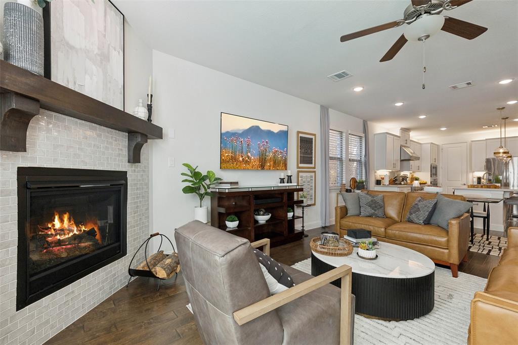 2236 Madison Street Carrollton, TX 75010 - Photo 8 of 37 a living room with furniture a fireplace and a flat screen tv