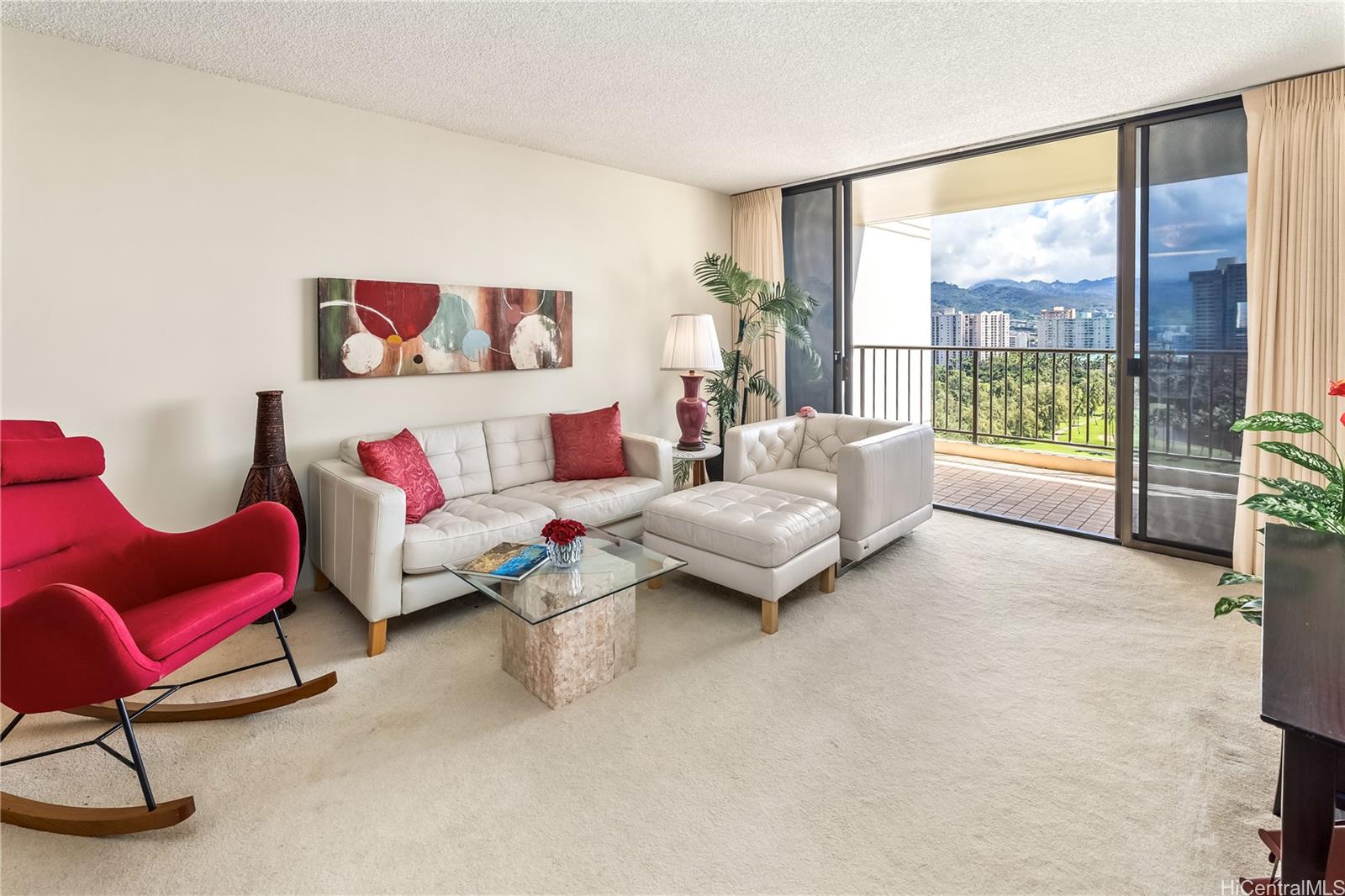 990 Ala Nanala Street, Unit 17A Honolulu, HI 96818 - Photo 20 of 24 a living room with furniture and a floor to ceiling window