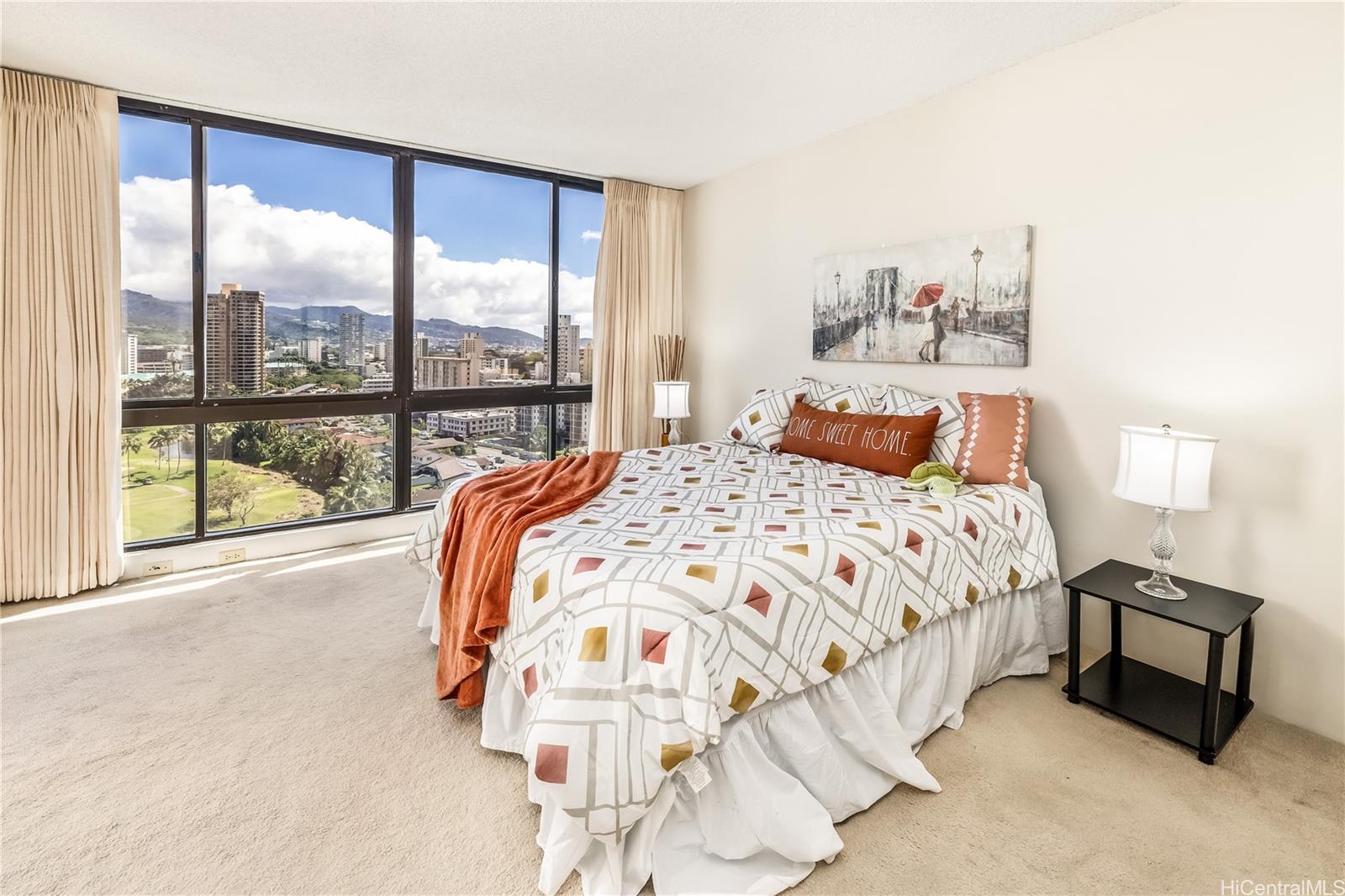 990 Ala Nanala Street, Unit 17A Honolulu, HI 96818 - Photo 22 of 24 a bedroom with a bed and a large window