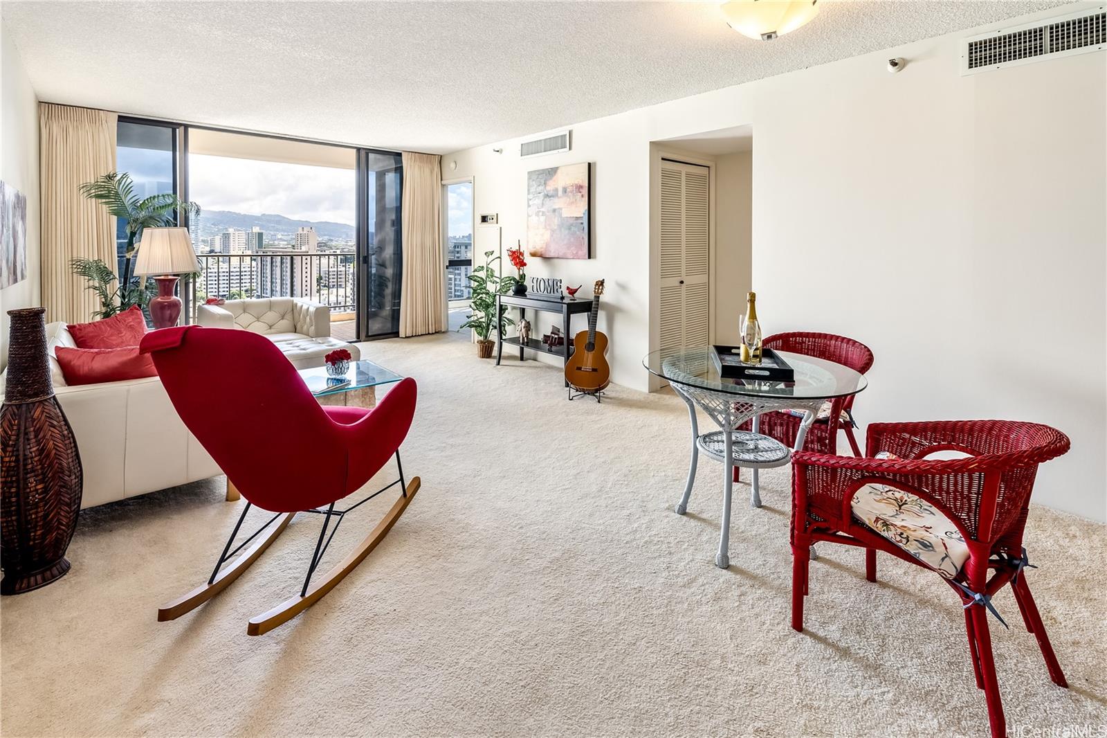990 Ala Nanala Street, Unit 17A Honolulu, HI 96818 - Photo 24 of 24 a living room with furniture and a floor to ceiling window