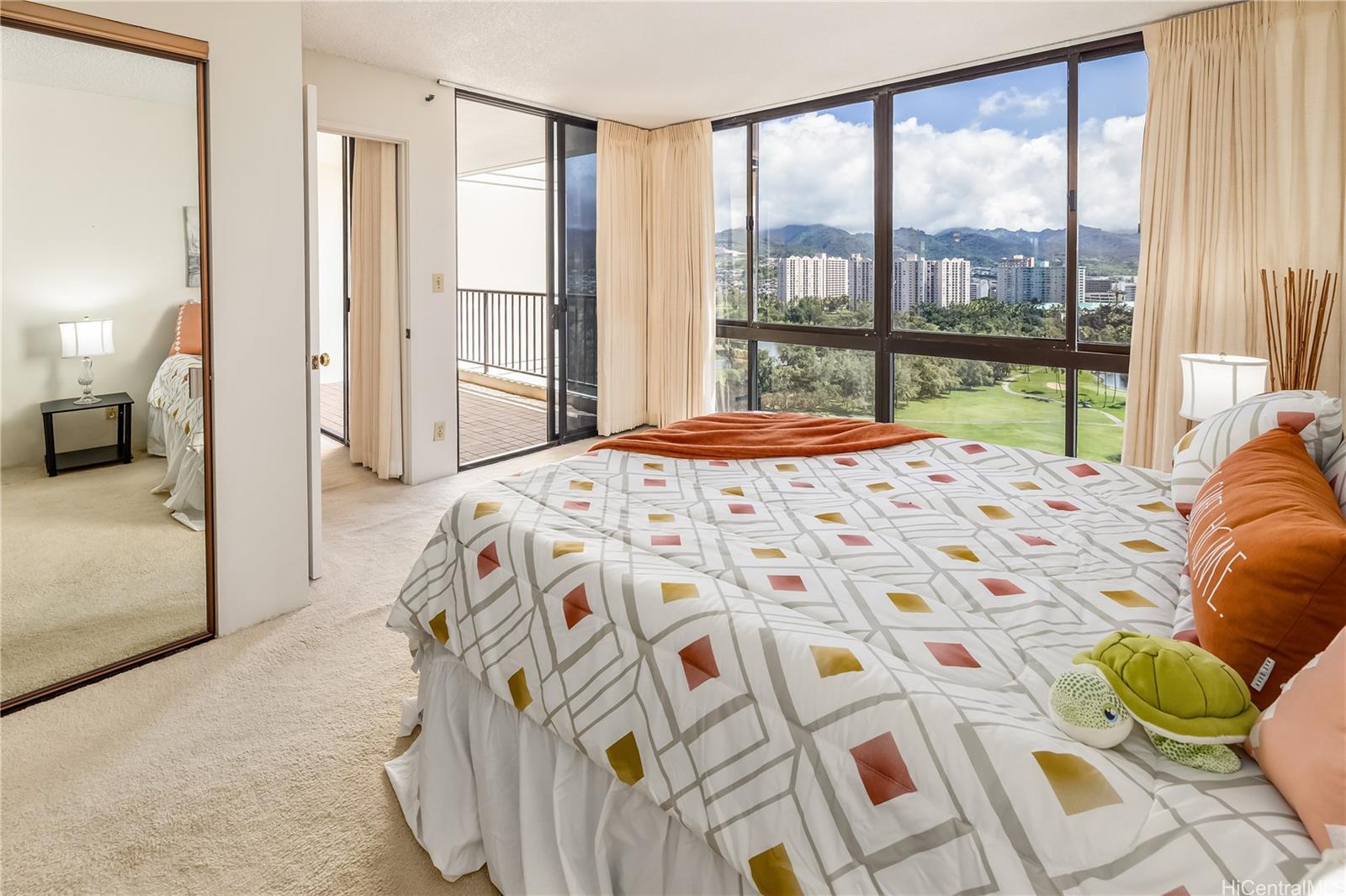 990 Ala Nanala Street, Unit 17A Honolulu, HI 96818 - Photo 5 of 24 a bedroom with a bed and large window