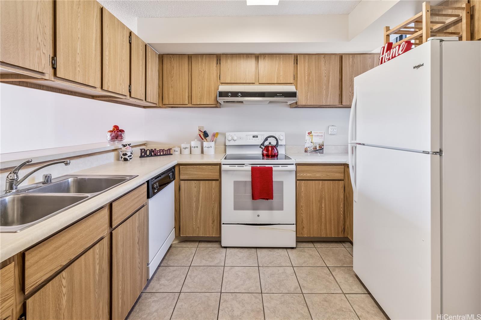 990 Ala Nanala Street, Unit 17A Honolulu, HI 96818 - Photo 7 of 24 a kitchen with a sink a refrigerator and cabinets