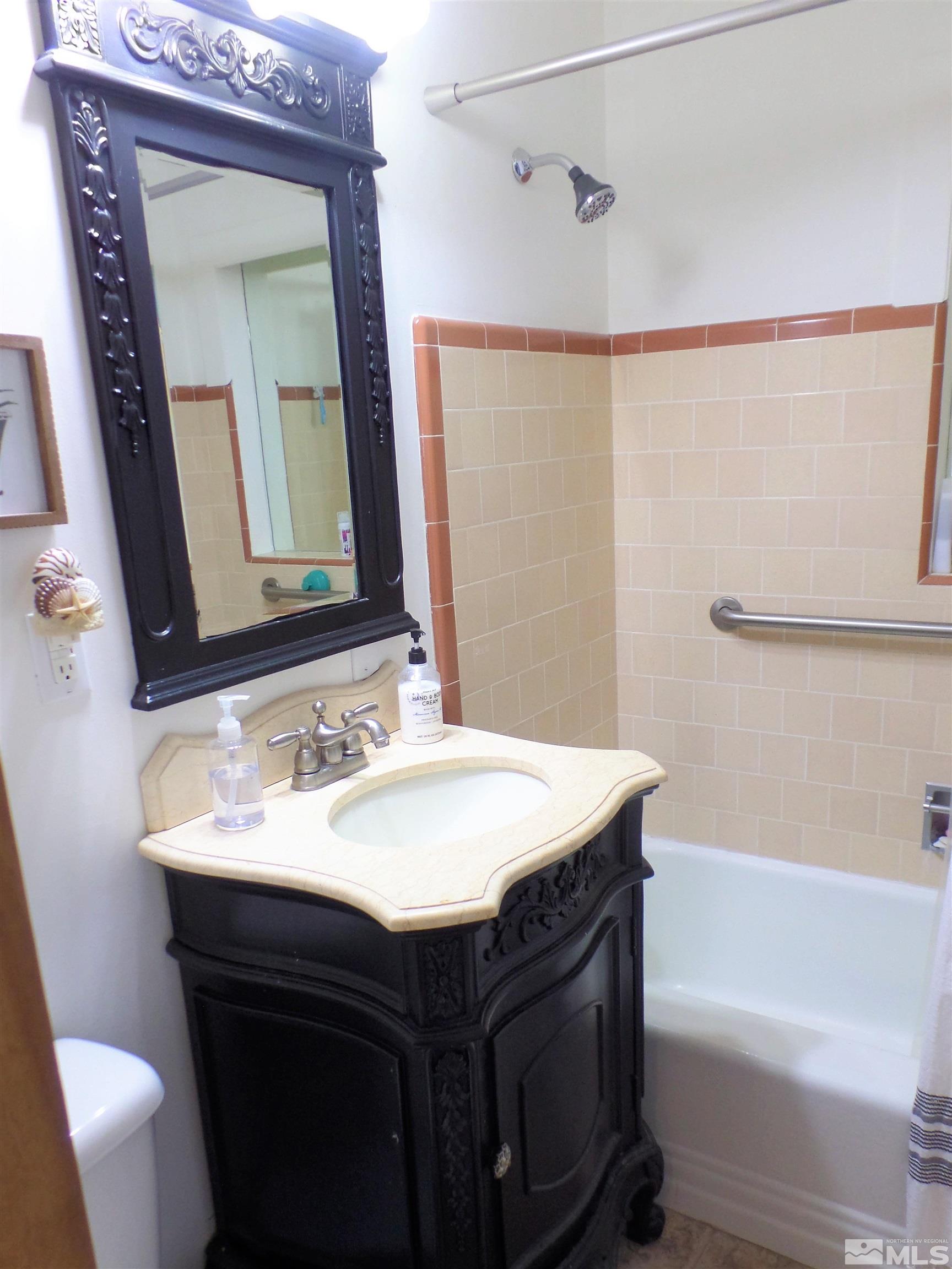 995 Memory Lane Reno, NV 89509 - Photo 15 of 33 a bathroom with a sink vanity mirror and toilet