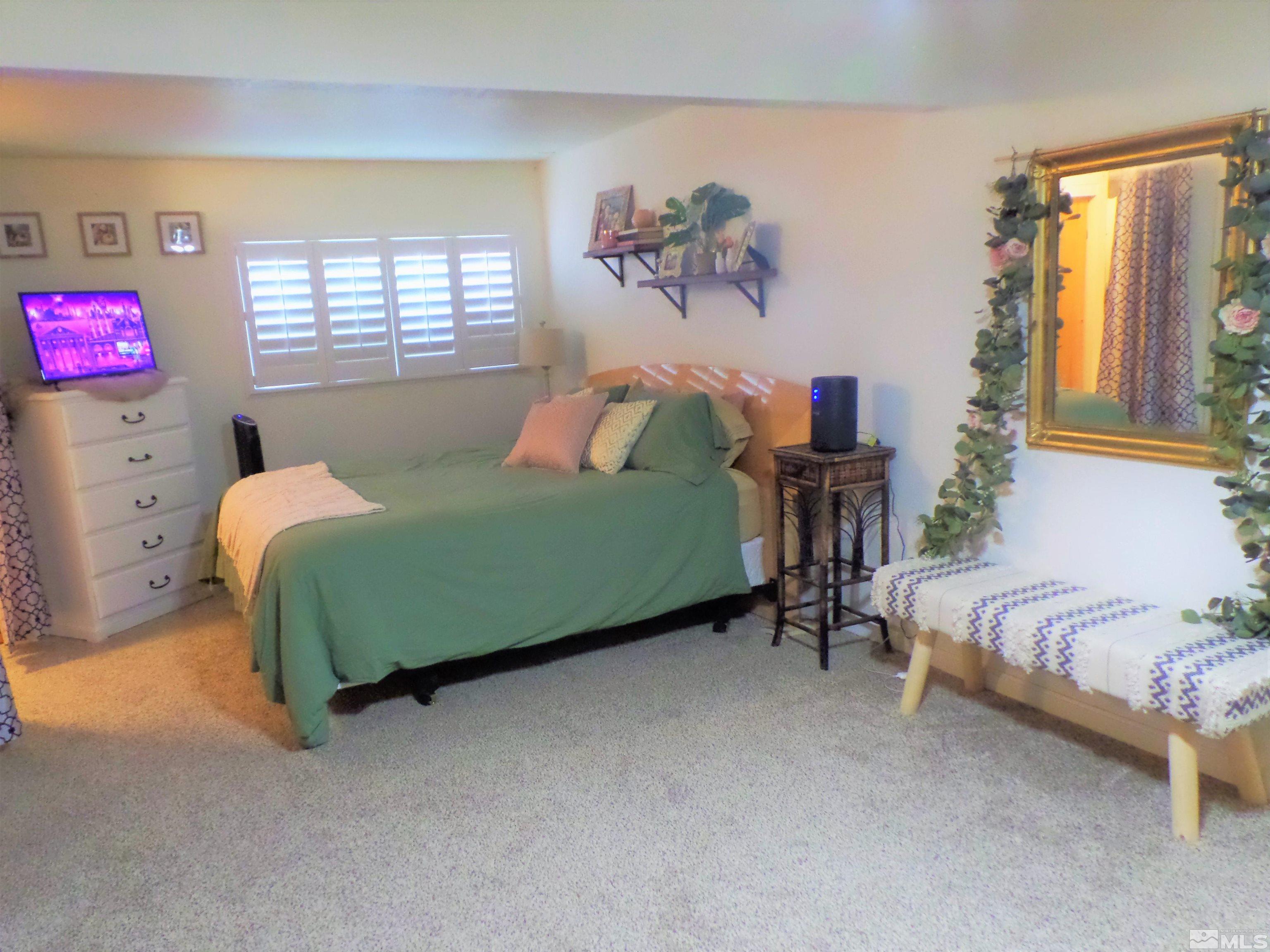 995 Memory Lane Reno, NV 89509 - Photo 23 of 33 a bedroom with a bed and a table chair
