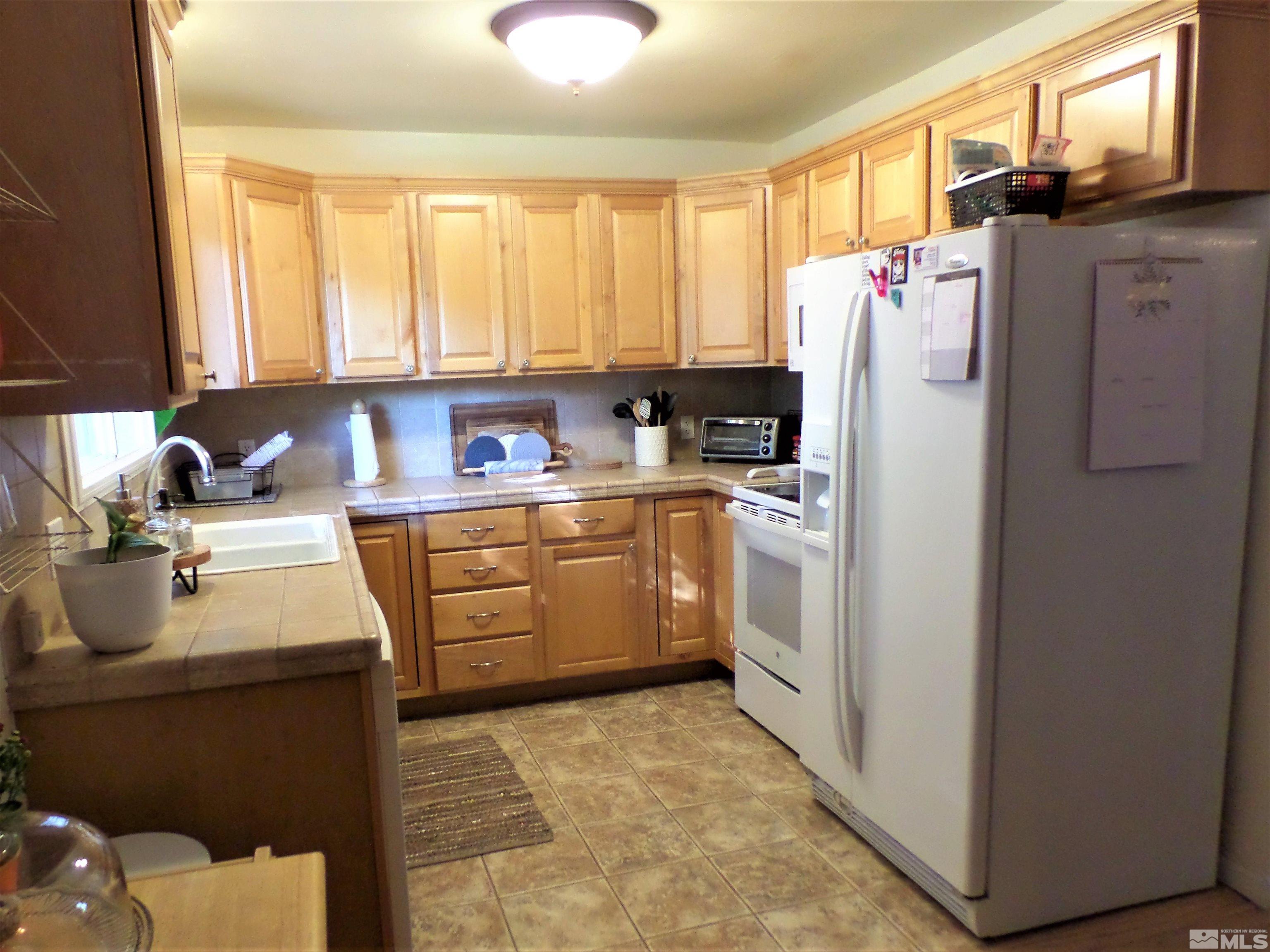 995 Memory Lane Reno, NV 89509 - Photo 8 of 33 a utility room with cabinets washer and dryer