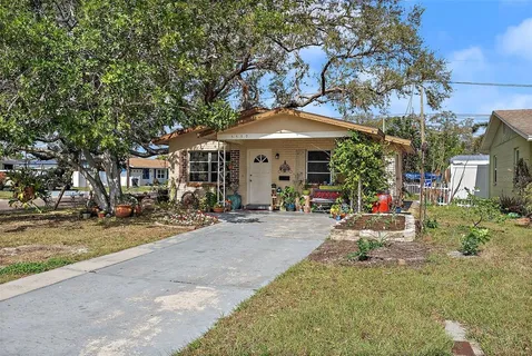 a view of a house with backyard porch and sitting area