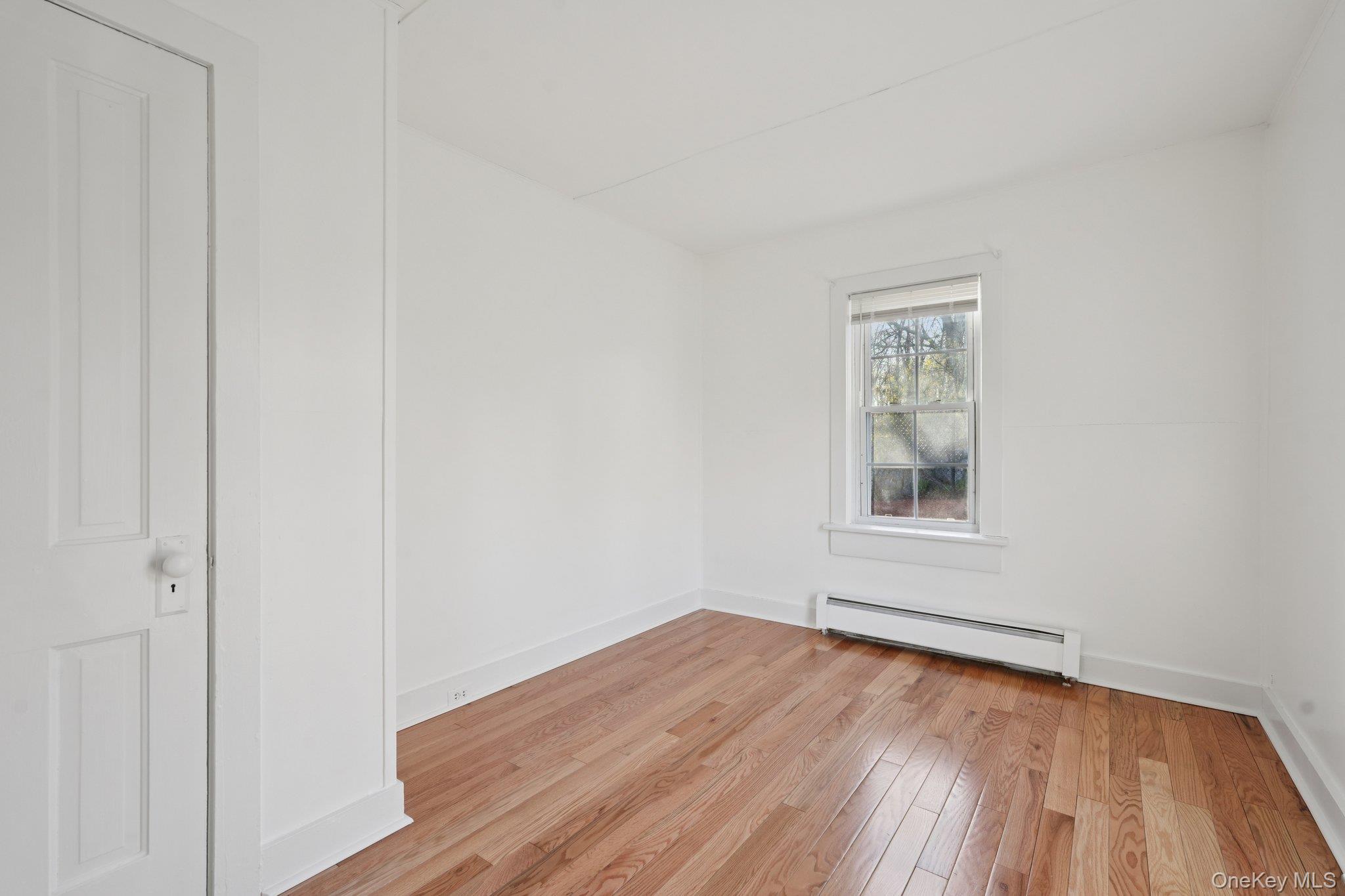 17 Pine Hill Road Highland Mills, NY 10930 - Photo 16 of 35 Bedroom with baseboard heating and light hardwood flooring