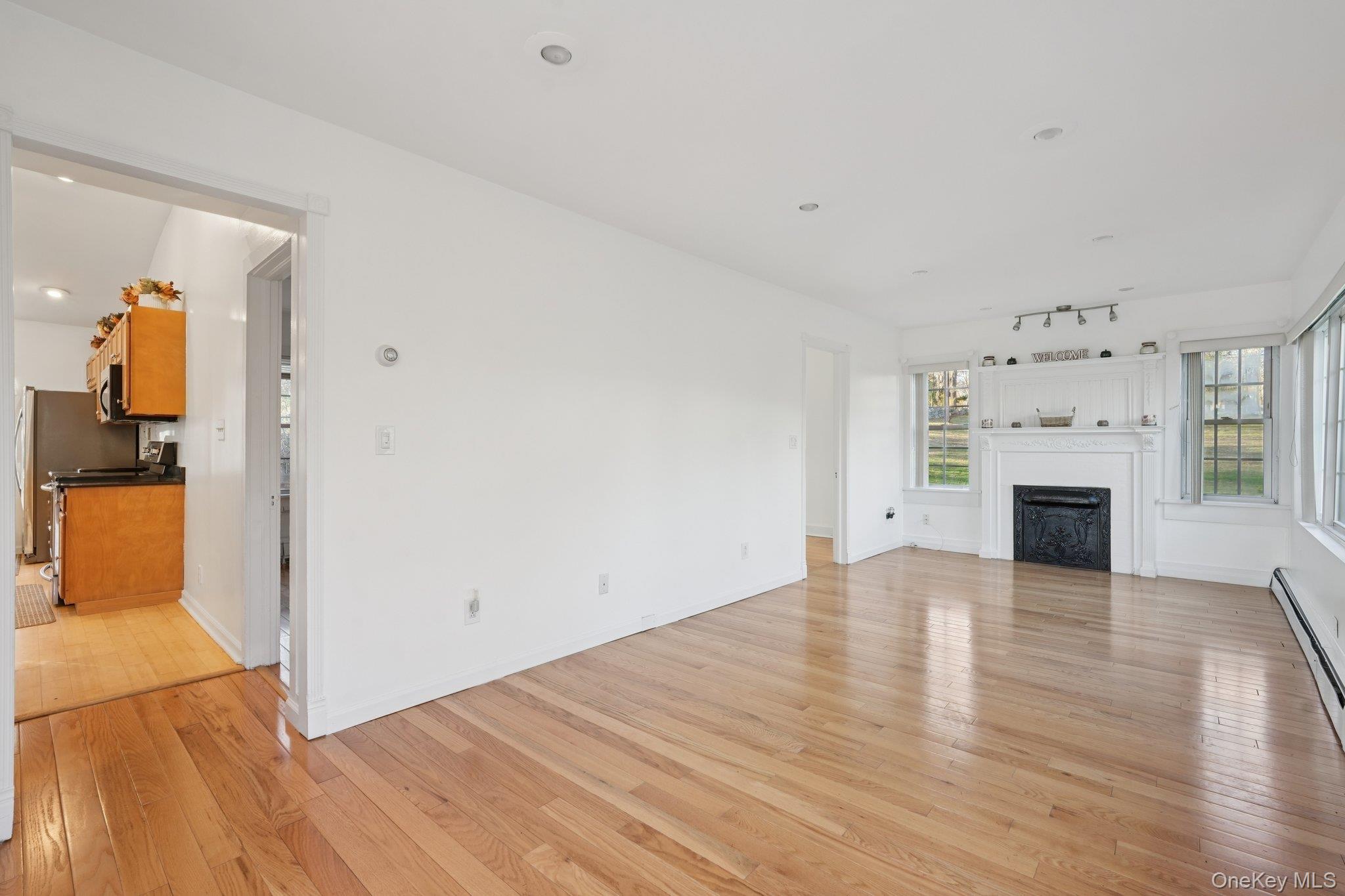 17 Pine Hill Road Highland Mills, NY 10930 - Photo 5 of 35 Bonus room with hardwood flooring, a fireplace, and baseboard heating