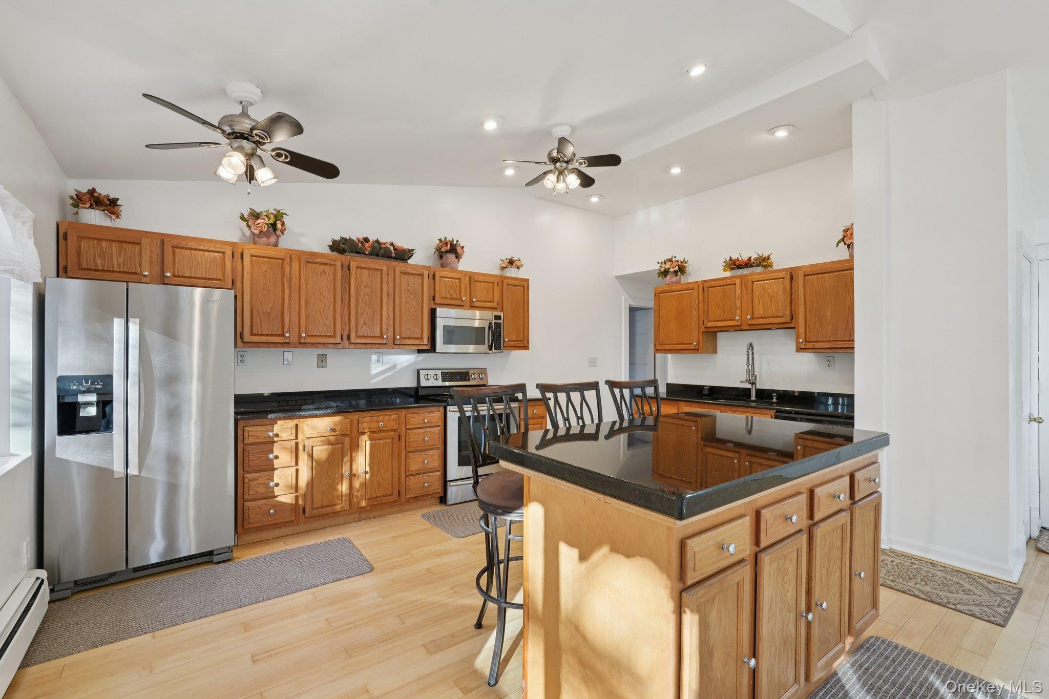 17 Pine Hill Road Highland Mills, NY 10930 - Photo 8 of 35 Kitchen with stainless steel appliances, ceiling fan, light hardwood floors, wood finish cabinets, and granite countertops