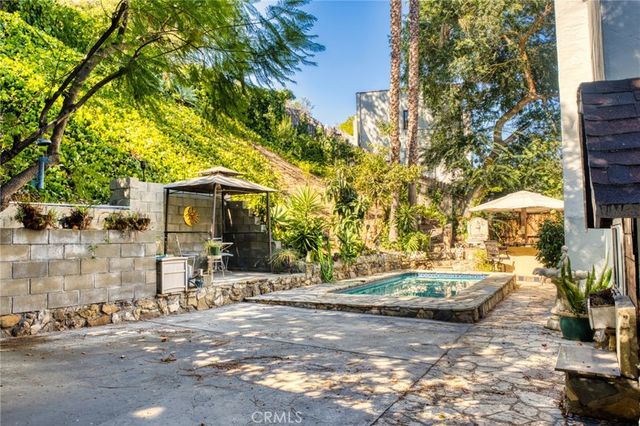 a view of a street with some cars parked on the road