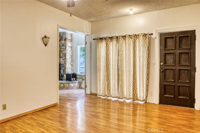 an empty room with wooden floor and closet