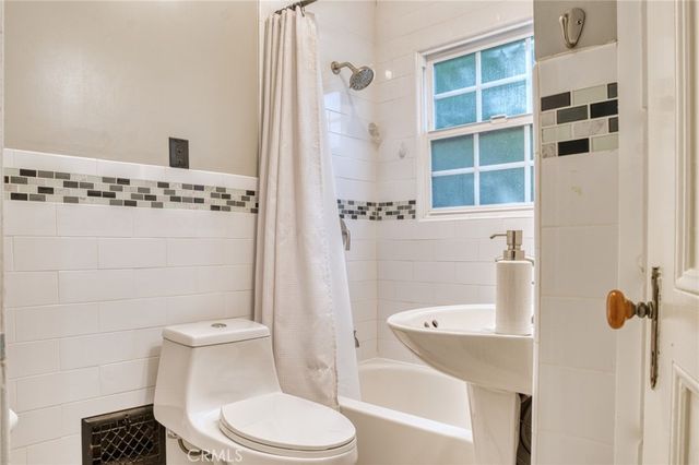 a white toilet sitting next to a bathroom sink