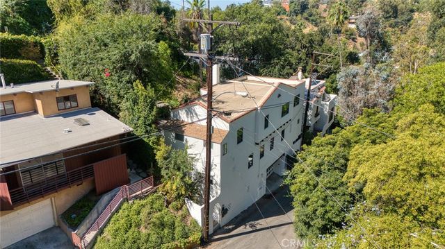 an aerial view of a house with a yard