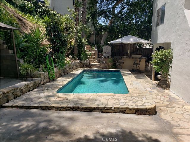 a view of swimming pool with a patio