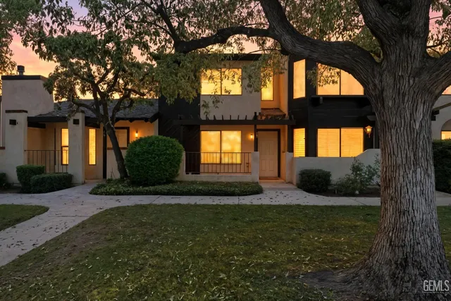 a view of a street with a couple of cars parked in front of it