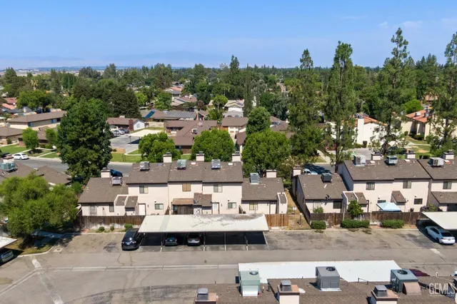 an aerial view of a house with garden space and street view