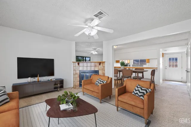 an empty room with ceiling fan and windows