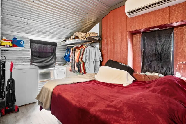 a bedroom with a bed and a closet