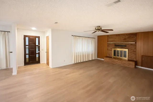 a view of an empty room with a fireplace