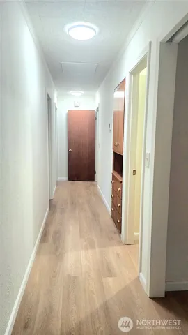 a view of a big room with closet and front door