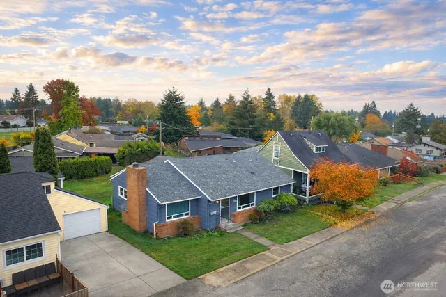 a view of a big house with a big yard plants and a big yard