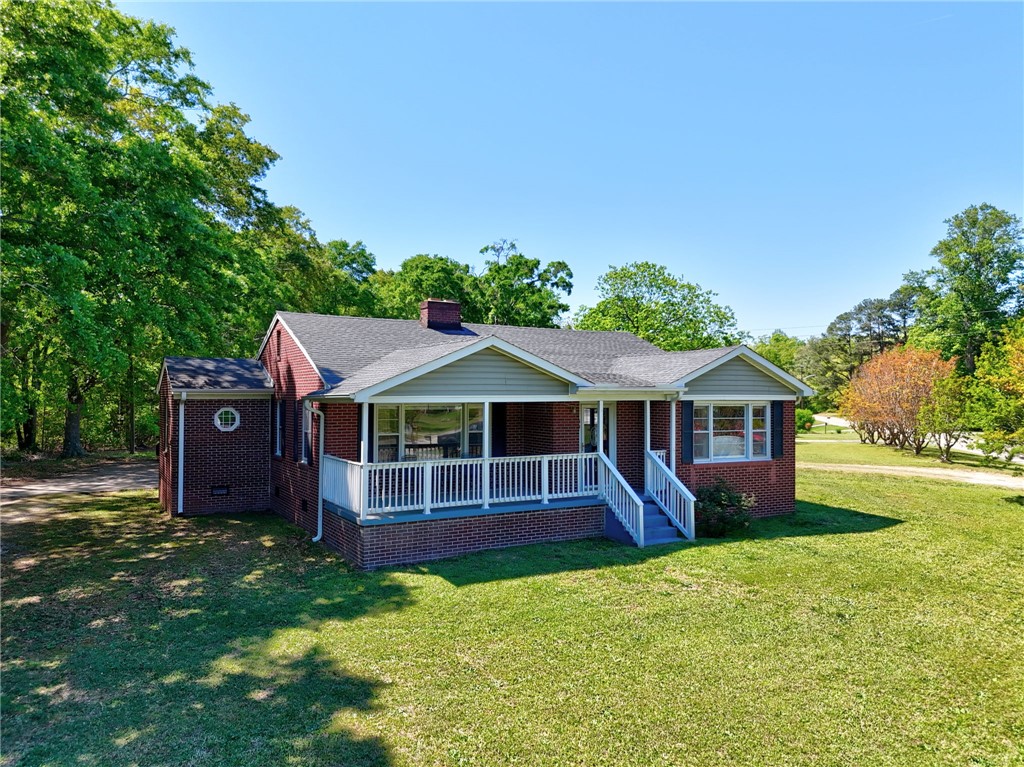 301 Clinkscales Street Iva, SC 29655 - Photo 1 of 36 Charming brick home with welcoming front porch nestled amidst mature trees and a spacious yard.