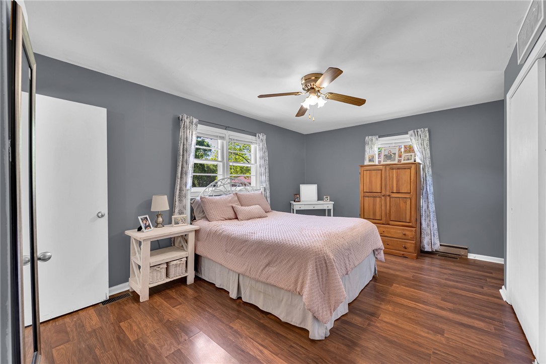 301 Clinkscales Street Iva, SC 29655 - Photo 11 of 36 This spacious bedroom offers ample natural light and beautiful wood flooring, creating a warm and inviting atmosphere.