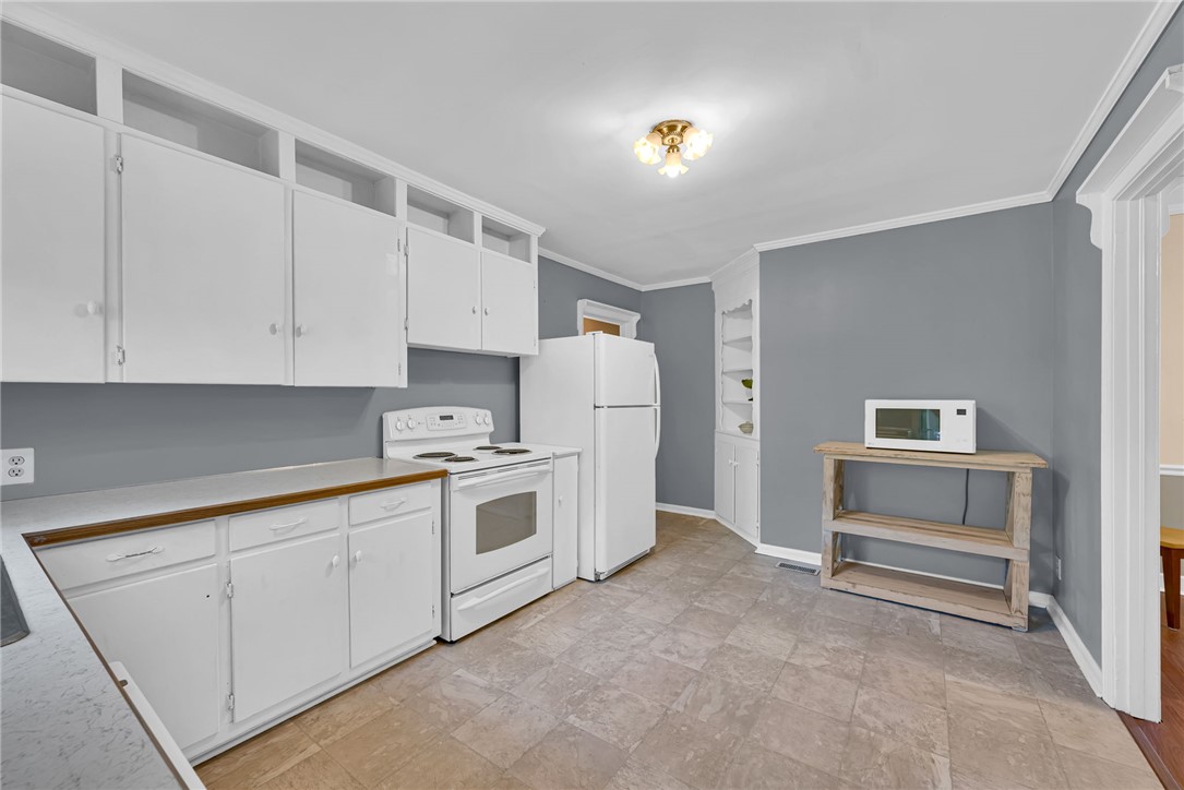 301 Clinkscales Street Iva, SC 29655 - Photo 12 of 36 This spacious kitchen offers ample cabinetry and an inviting atmosphere perfect for everyday living.