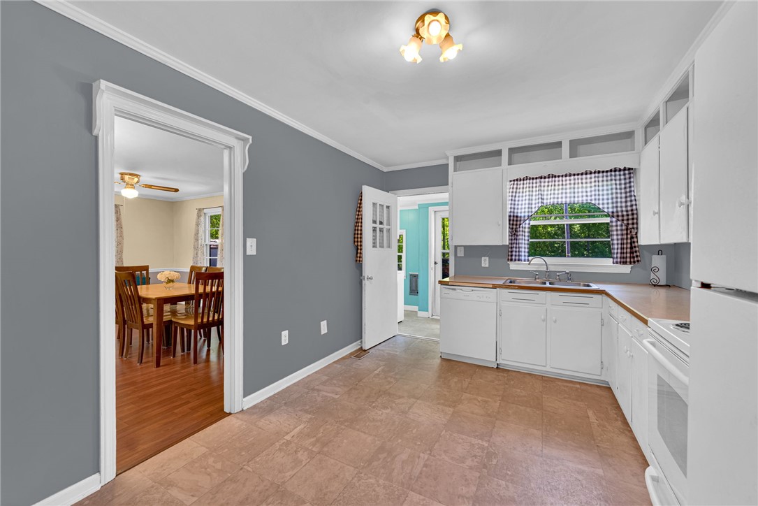 301 Clinkscales Street Iva, SC 29655 - Photo 13 of 36 This bright kitchen offers a practical layout with direct access to dining spaces and outdoor areas.