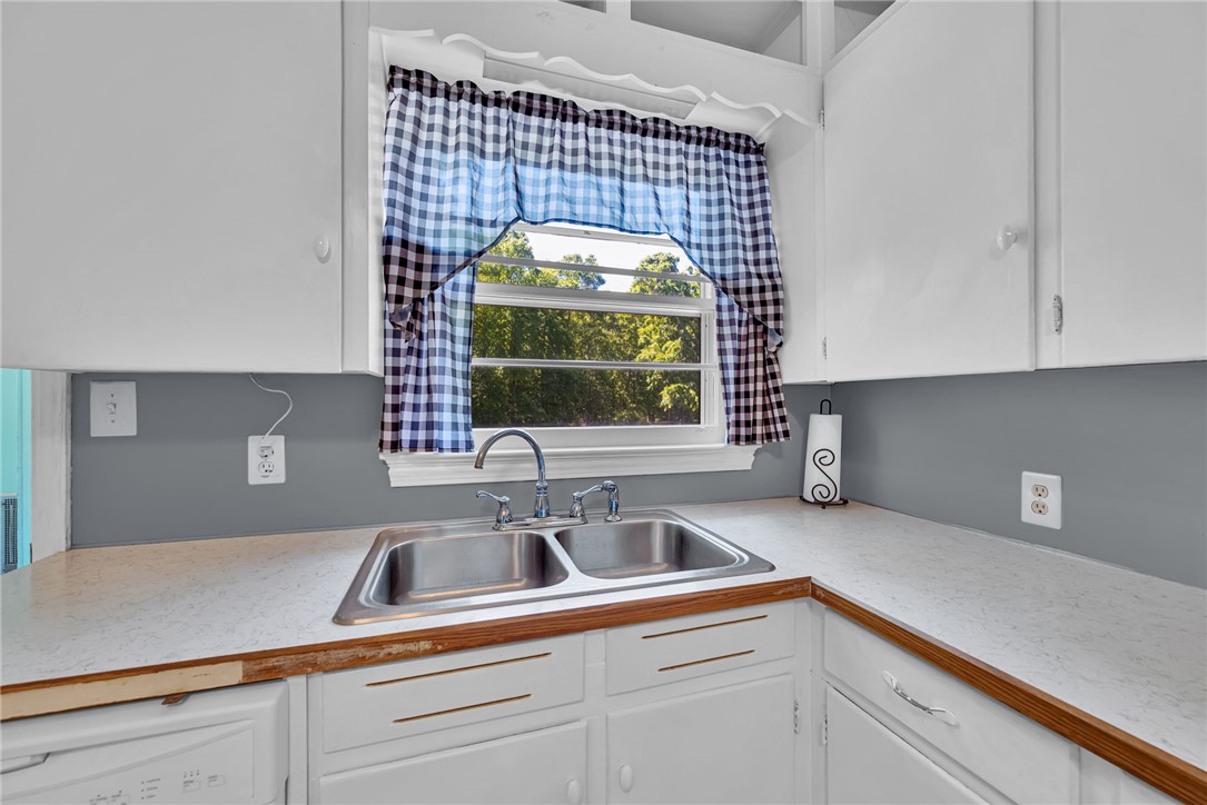 301 Clinkscales Street Iva, SC 29655 - Photo 14 of 36 This bright kitchen features ample cabinetry and a practical double-basin sink with a view.