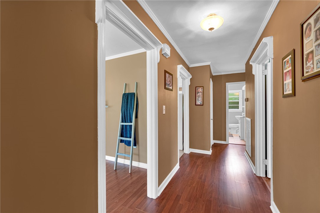 301 Clinkscales Street Iva, SC 29655 - Photo 19 of 36 Rich hardwood flooring guides you through this home's inviting hallway, offering seamless transitions.
