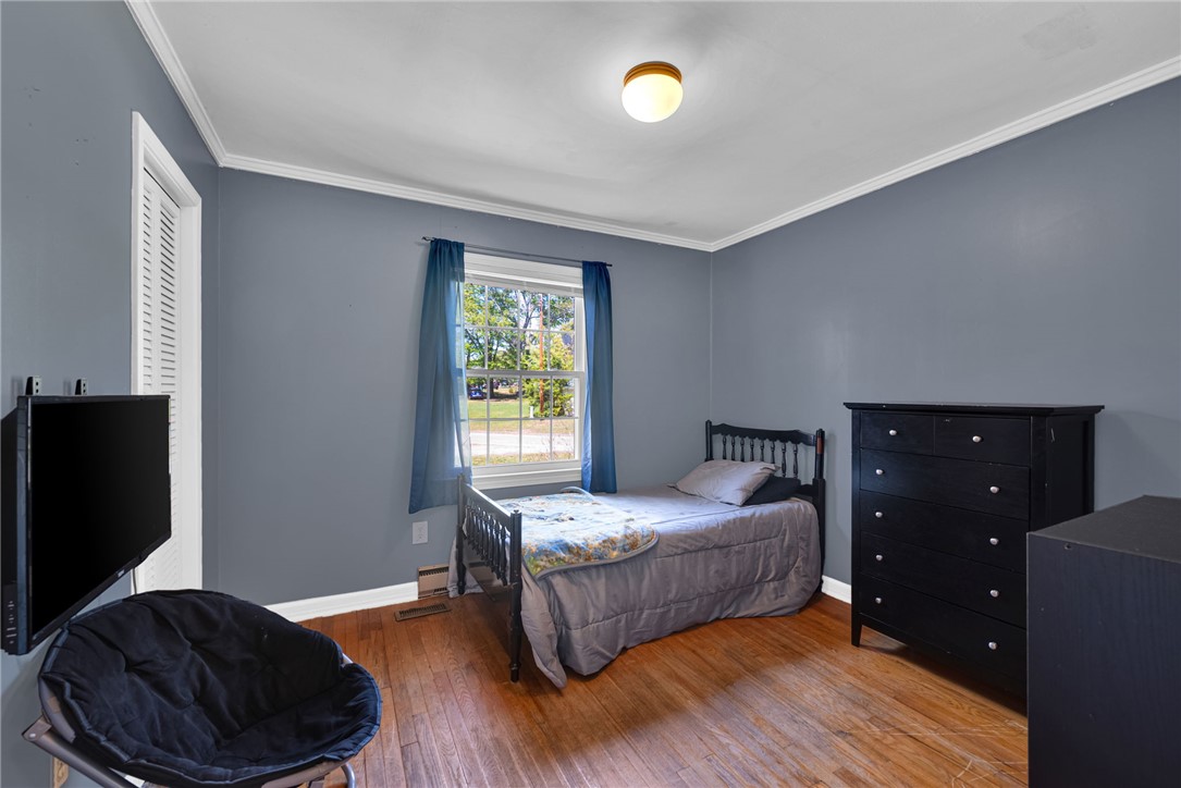 301 Clinkscales Street Iva, SC 29655 - Photo 20 of 36 This cozy bedroom features durable hardwood flooring and a classic ceiling light fixture.