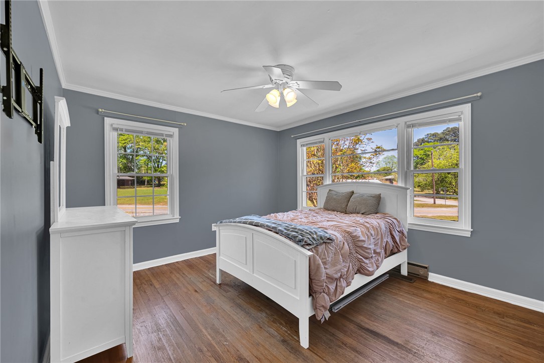 301 Clinkscales Street Iva, SC 29655 - Photo 21 of 36 This serene bedroom offers hardwood floors and ample natural light, creating a peaceful retreat.