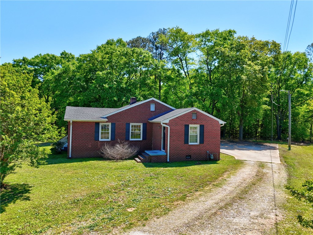 301 Clinkscales Street Iva, SC 29655 - Photo 22 of 36 This charming brick residence is nestled among mature trees, offering a serene and private setting.
