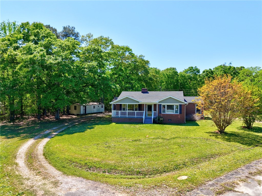 301 Clinkscales Street Iva, SC 29655 - Photo 23 of 36 This charming home features a lovely front porch, lush green lawn, and mature trees.