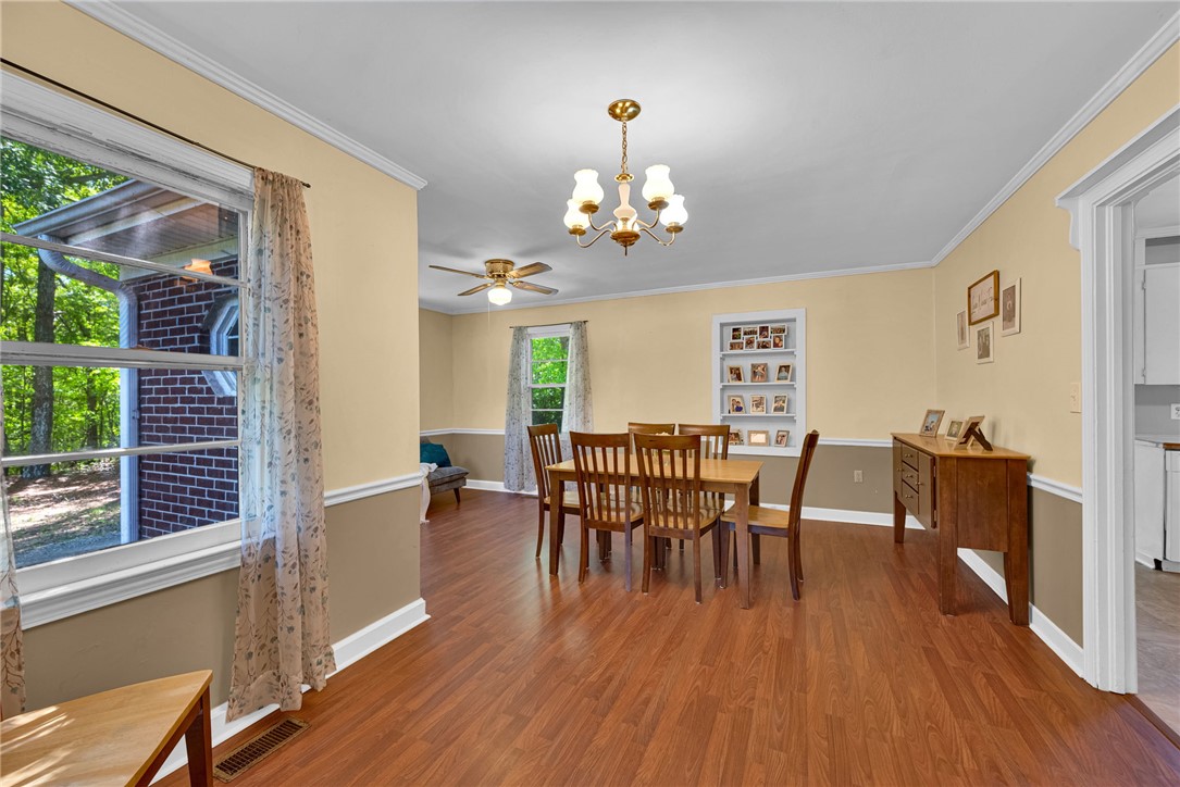 301 Clinkscales Street Iva, SC 29655 - Photo 5 of 36 This spacious dining room features elegant flooring, ample natural light, and classic architectural details.