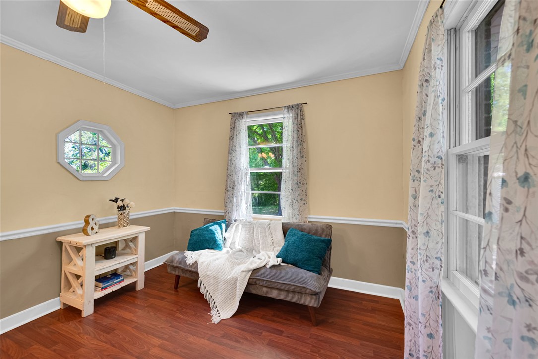 301 Clinkscales Street Iva, SC 29655 - Photo 7 of 36 This inviting room features warm wood flooring and ample natural light, creating a comfortable living space.