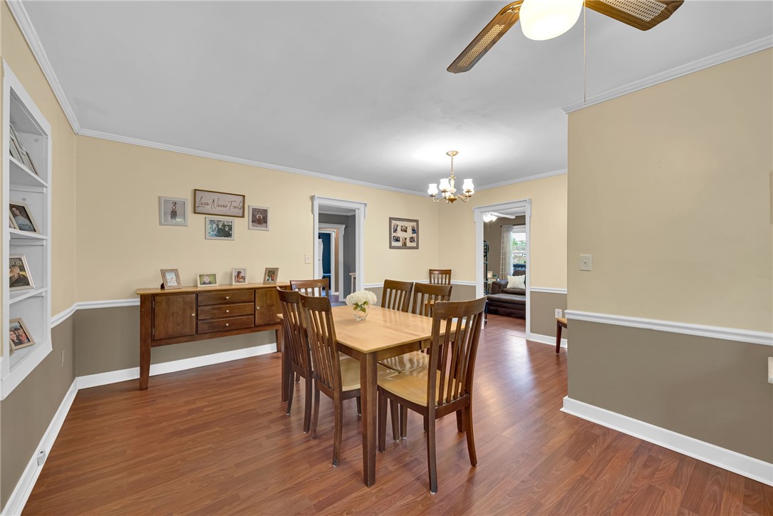 301 Clinkscales Street Iva, SC 29655 - Photo 8 of 36 This dining room offers warm wood flooring, a ceiling fan, and chandelier.