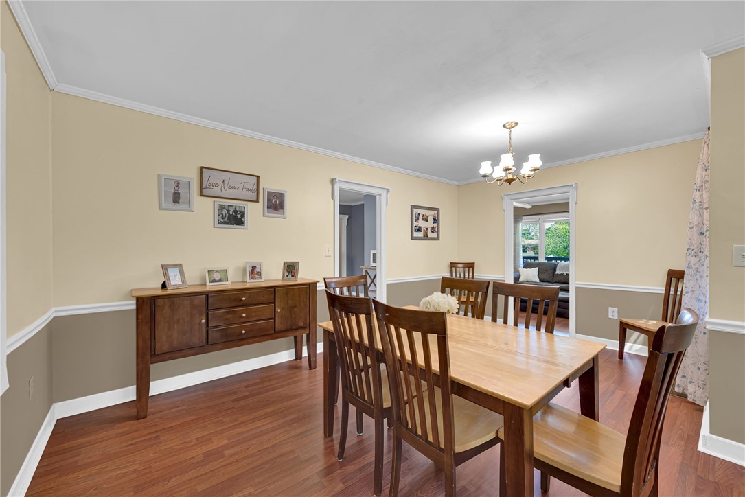 301 Clinkscales Street Iva, SC 29655 - Photo 9 of 36 This dining area features rich wood flooring, crown molding, and a charming chandelier.