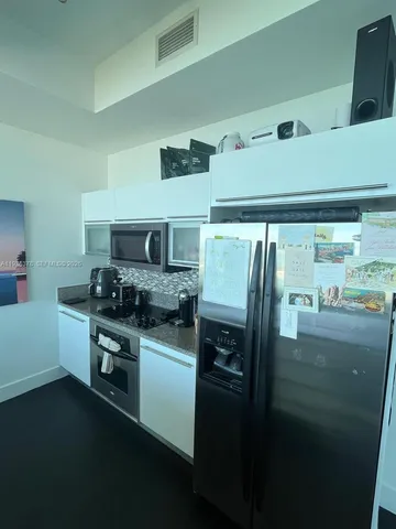 a kitchen with granite countertop a sink and stove top oven