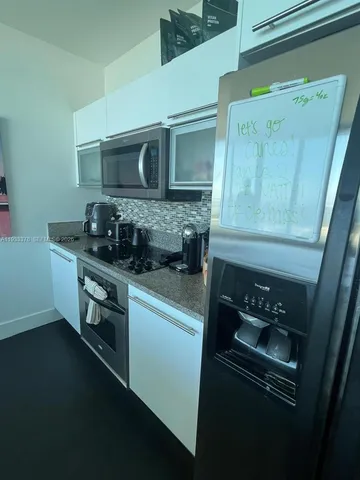 a kitchen with a refrigerator and a stove