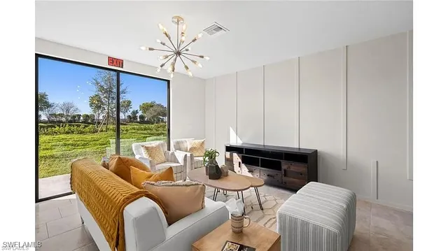 a living room with furniture and a floor to ceiling window