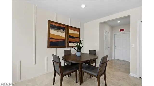 a dining room with furniture and wooden floor