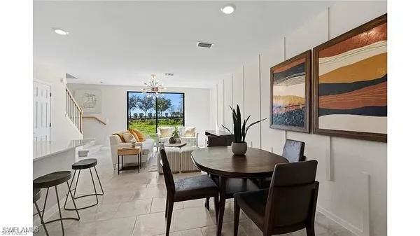 a dining room with furniture and window