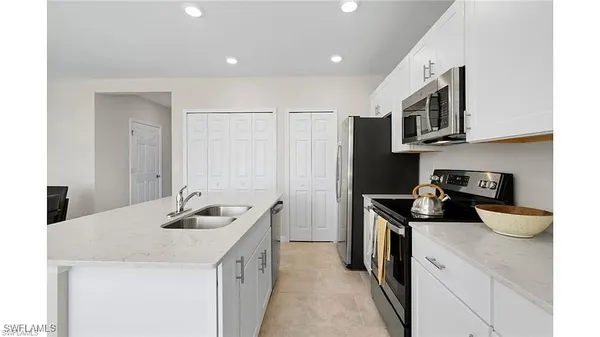 a kitchen with stainless steel appliances granite countertop a sink and cabinets