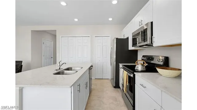 a kitchen with stainless steel appliances granite countertop a sink and cabinets