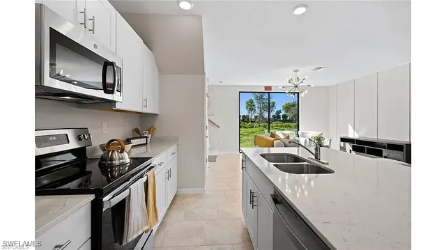 a kitchen with a sink stove and microwave
