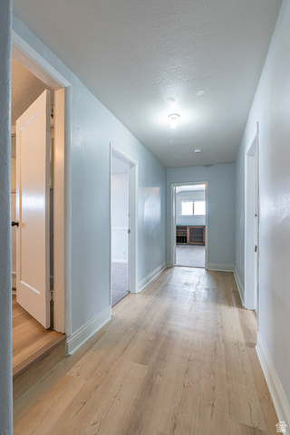 33 North 200 East Logan, UT 84321 - Photo 25 of 54 Corridor with light wood-type flooring and a textured ceiling